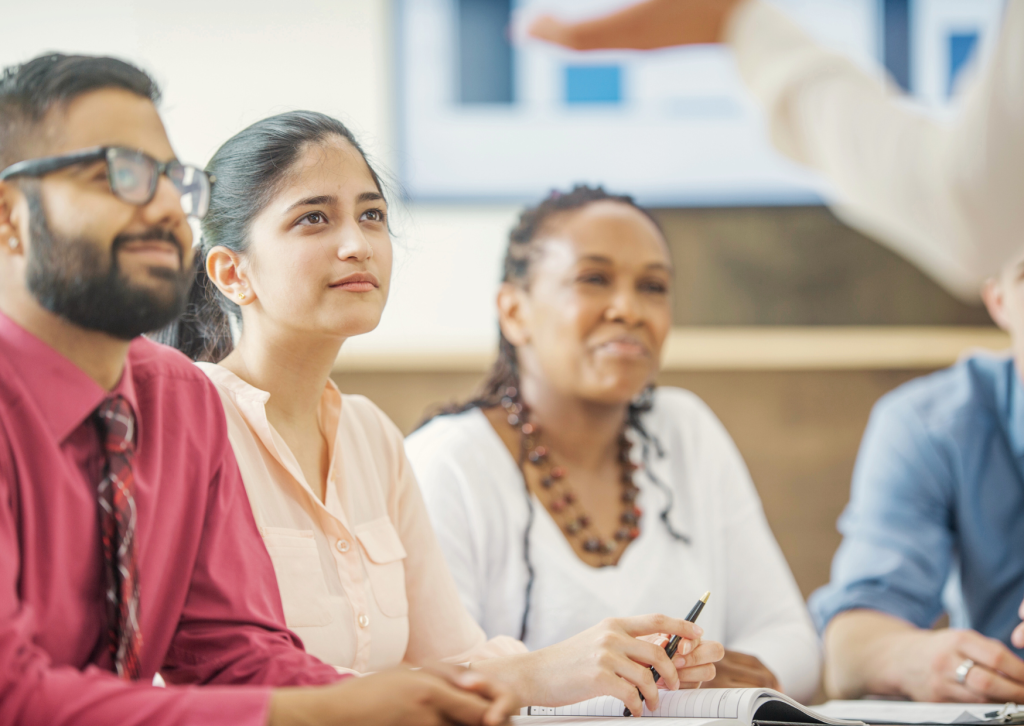 Adult learners listening to a tutor during a classroom session, demonstrating inclusive learning and professional development with Open Awards.